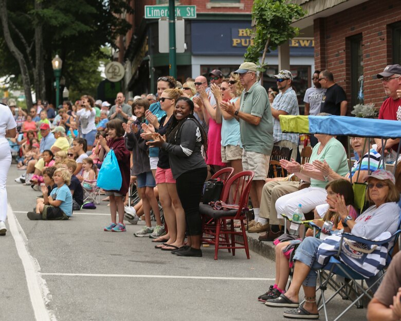 Residents cheer as Marines and Sailors with Combat Logistics Battalion 8, 2nd Marine Logistics Group march down the streets of Rockland, ME during the Lobster Fest parade, Aug. 6, 2016. The Marines and Sailors with the unit aboard the USS Oak Hill (LSD-51) were in port Aug. 3-7 to participate in the festival and display the expeditionary capabilities of the Navy-Marine Corps team. (U.S. Marine Corps photo by Sgt. Olivia McDonald)
