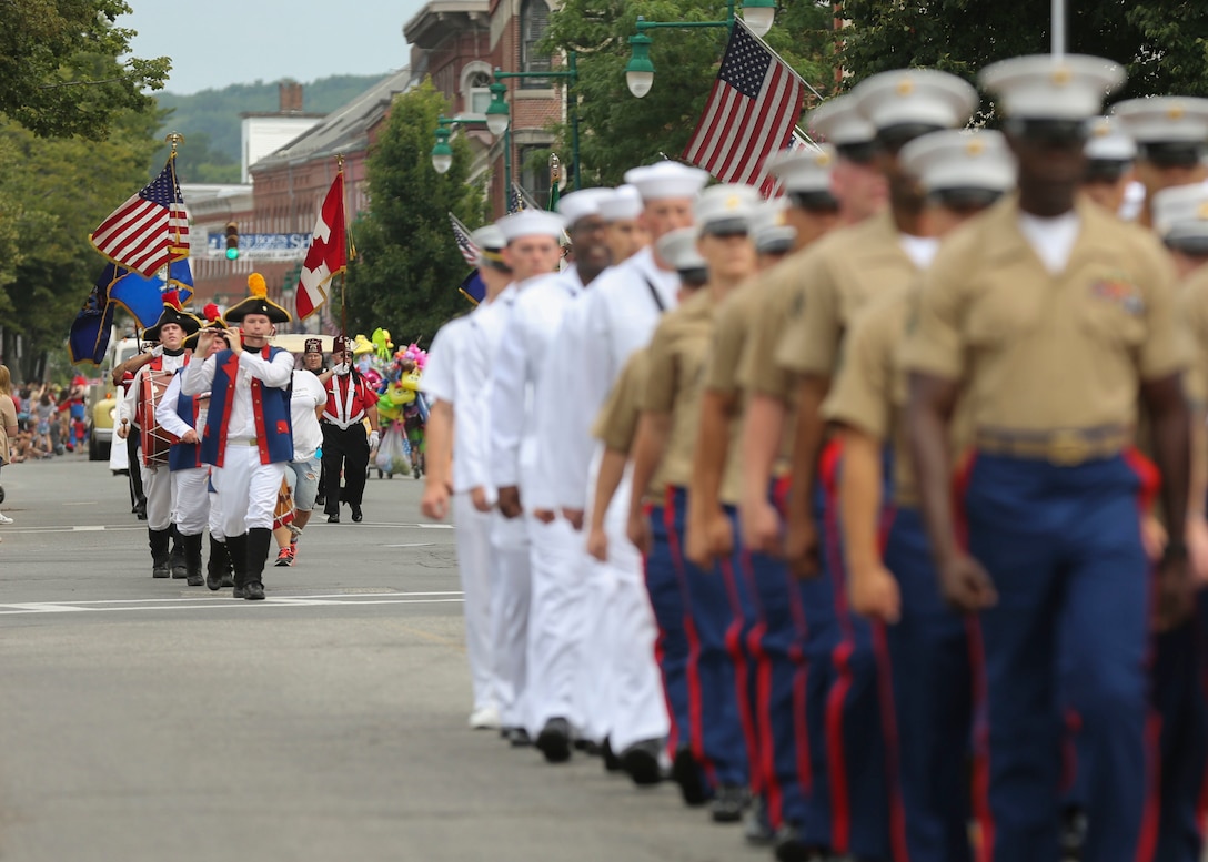 Participants in Lobster Fest 2016 march behind a formation of Marines and sailors during a parade in Rockland, ME, Aug. 6, 2016. The Marines and Sailors with Combat Logistics Battalion 8, 2nd Marine Logistics Group, aboard the USS Oak Hill (LSD-51), were in port Aug. 3-7 to participate in the festival and display the expeditionary capabilities of the Navy-Marine Corps team. (U.S. Marine Corps photo by Sgt. Olivia McDonald)