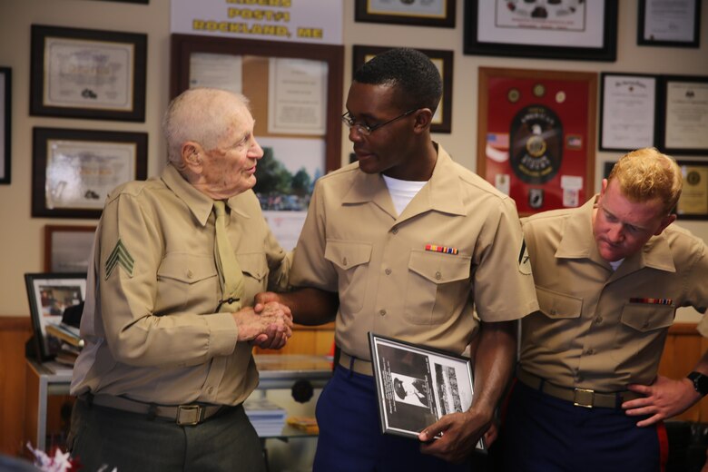 Retired Marine Sgt. Leory Peasley (left), an Iwo Jima veteran, meets some of the Marines aboard the USS Oak Hill (LSD-51) at the local American Legion in Rockland, ME, Aug. 6, 2016. The Marines and Sailors with Combat Logistics Battalion 8, 2nd Marine Logistics Group, aboard the USS Oak Hill, were in port Aug. 3-7 to participate in the Lobster Festival and display the expeditionary capabilities of the Navy-Marine Corps team. (U.S. Marine Corps photo by Sgt. Olivia McDonald)
