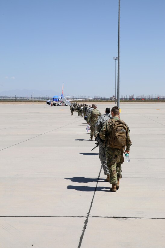 Soldiers with Headquarters and Headquarters Company, 96th Military Police Battalion, U.S. Army Reserve board a flight to Guantanamo Naval Base, Cuba at the Silas L. Copeland Arrival/Departure Airfield Control Group here July 20.