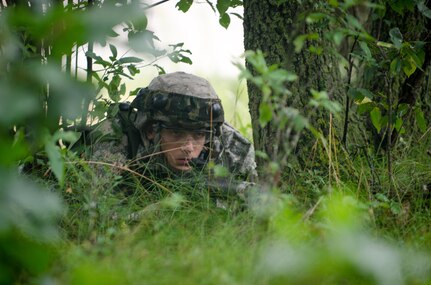 U.S. Army Reserve Spc. Alexander Hochschild, attached to the 652nd Engineering Company, Hammond, Wis., monitors a section of woodland for movement while other Soldiers setup a dry support bridge during Combat Support Training Exercise (CSTX) 86-16-03 at Fort McCoy, Wis., August 11, 2016. The 84th Training Command’s third and final Combat Support Training Exercise of the year hosted by the 86th Training Division at Fort McCoy, Wis. is a multi-component and joint endeavor aligned with other reserve component exercises. (U.S. Army photo by Spc. Cody Hein/Released)