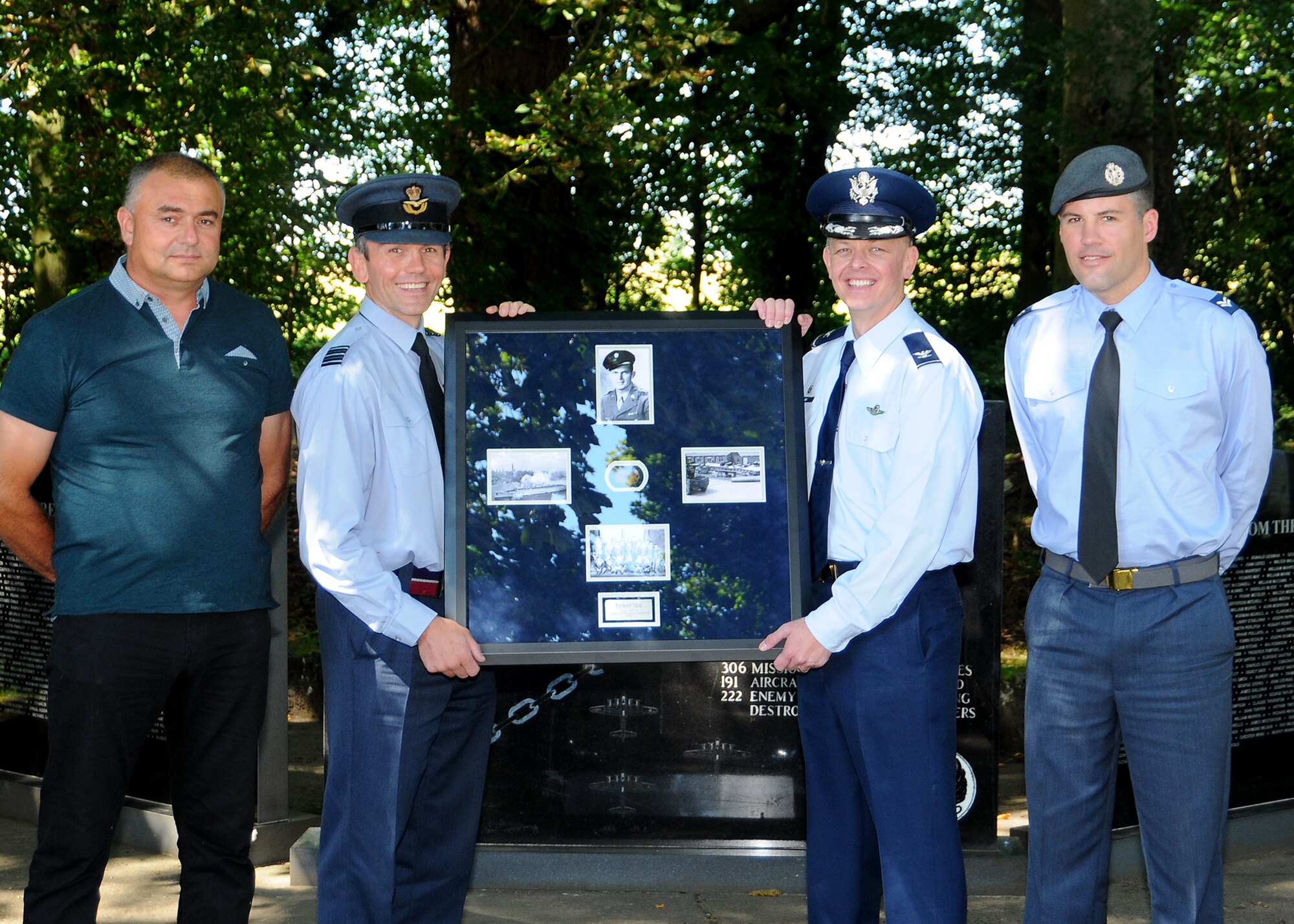 Andy Fuller, dog tag finder, Wing Commander Cornish, officer commanding support wing, Royal Air Force Honington, U.S. Air Force Col. Derek Salmi, 100 Air Refueling Wing, Operations Group commander, RAF Mildenhall, U.K., and Cpl. Ed Stanley, RAF armourer and RAF military contact for Fuller pose in front of the 388th Bombardment Group (Heavy), 8th AF memorial with a WWII U.S. Army Air Forces dog tag that was found while metal detecting on the former RAF Knettishall (US Air Base 136) near Knettishall, U.K., Aug. 12, 2016. This repatriation of the service member's dog tag marked the official receipt from the RAF to the USAF on behalf of the surviving USAAF service member who was assigned to the 388th BG, 8th AF and is currently living in Louisiana. Following this ceremony, the dog tag will be transported to the 8th AF in Louisiana where it can then be officially presented to its rightful owner. (U.S. Air Force photo by Senior Master Sgt. Brian M. Boisvert)
