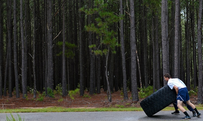 U.S. Airmen assigned to the 20th Fighter Wing flip a tractor tire during a Comprehensive Airman Fitness sports day at Shaw Air Force Base, S.C., Aug. 10, 2016. The tractor tire flip was part of the “Amazing Race” event which tested Airmen’s Air Force knowledge, as well as their physical strength. (U.S. Air Force photo by Airman 1st Class Christopher Maldonado)