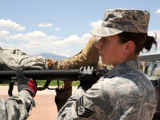 FORT CARSON, Colo. – Staff Sgt. Sharon Murphy, 302nd Aeromedical Evacuation Squadron medical technician, carries a litter with a simulated patient to an M997 Field Litter Ambulance during a combat medical training exercise, July 16, 2016 here. The 302nd ASTS Critical Care Air Transport Team trained on combat casualty care procedures with the Army National Guardsmen from the 928th Area Support Medical Company in preparation to support the 82nd Airborne Division Joint Readiness Training Center later this year. (U.S. Air Force photo/Staff Sgt. Amber Sorsek)