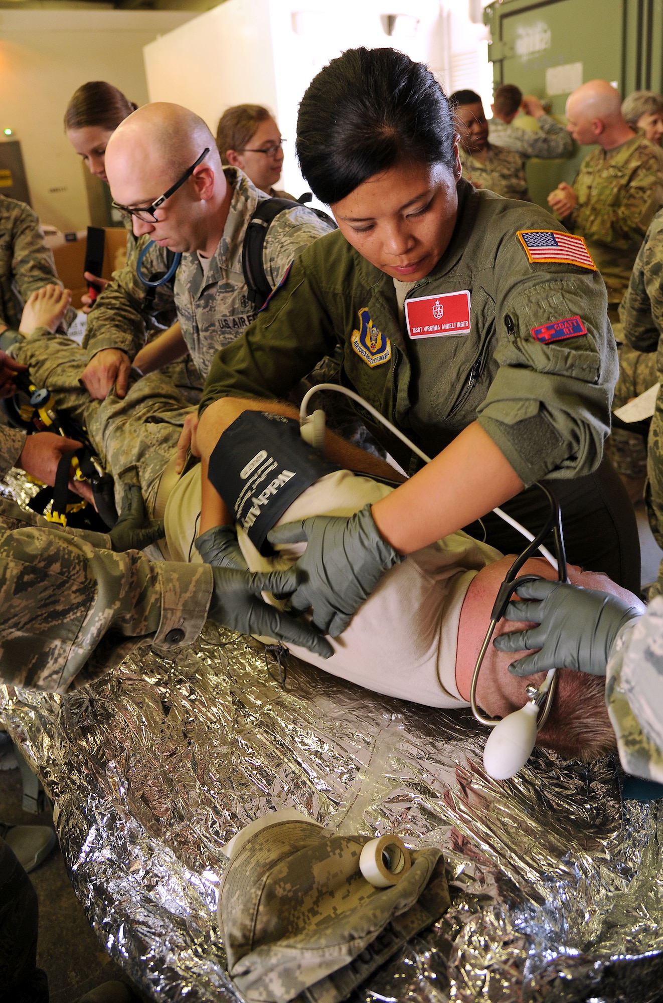 FORT CARSON, Colo. – Master Sgt. Virginia Andelfinger, 302nd Aeromedical Evacuation Squadron respiratory therapist, checks a simulated patient for injury during a combat medical training exercise, July 16, 2016 here. The Air Force Reserve Command’s 302nd Aeromedical Support Squadron Critical Care Air Transport Team and Army National Guardsmen from the 928th Area Support Medical Company trained jointly in tactical ground medical evacuation procedures in preparation to support the 82nd Airborne Division Joint Readiness Training Center later this year. (U.S. Air Force photo/Staff Sgt. Amber Sorsek)