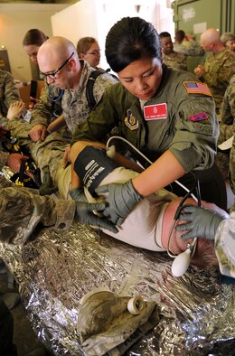 FORT CARSON, Colo. – Master Sgt. Virginia Andelfinger, 302nd Aeromedical Evacuation Squadron respiratory therapist, checks a simulated patient for injury during a combat medical training exercise, July 16, 2016 here. The Air Force Reserve Command’s 302nd Aeromedical Support Squadron Critical Care Air Transport Team and Army National Guardsmen from the 928th Area Support Medical Company trained jointly in tactical ground medical evacuation procedures in preparation to support the 82nd Airborne Division Joint Readiness Training Center later this year. (U.S. Air Force photo/Staff Sgt. Amber Sorsek)