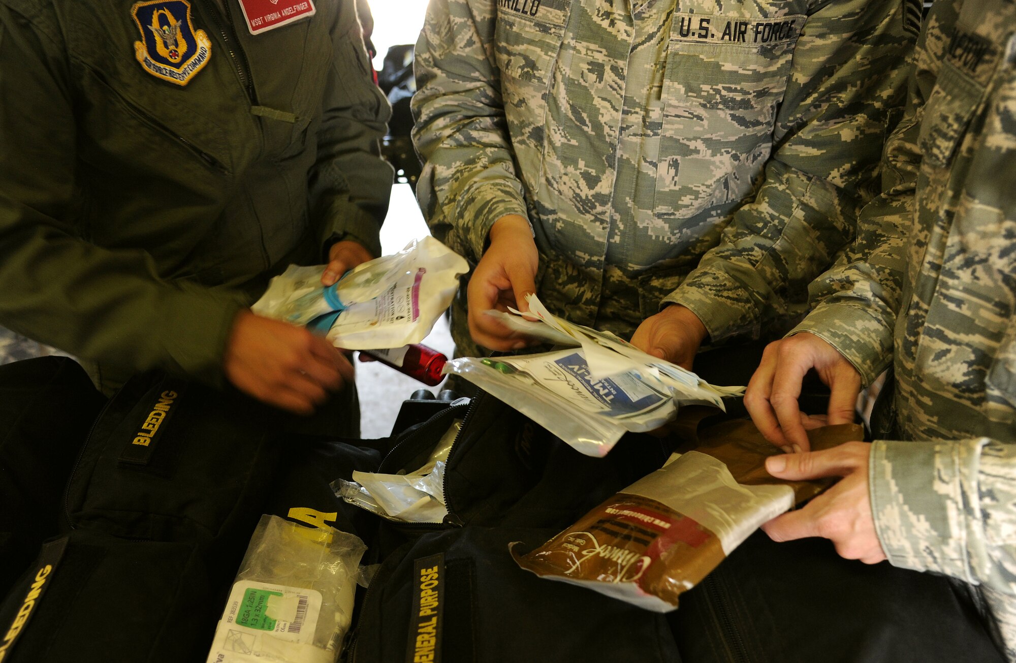 FORT CARSON, Colo. – Members from the Air Force Reserve Command’s 302nd Aeromedical Staging Squadron prepare medical field kits during a combat medical training exercise, July 16, 2016 here. This training prepares Air Force Reservists for real-world wartime missions. The 302nd  ASTS Critical Care Air Transport Team and Army National Guardsmen from the 928th Area Support Medical Company trained jointly covering tactical ground medical evacuation procedures in preparation to support the 82nd Airborne Division Joint Readiness Training Center later this year. (U.S. Air Force photo/Staff Sgt. Amber Sorsek)