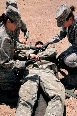 FORT CARSON, Colo. – Capt. Dena Leyba, left, and Staff Sgt. Sharon Murphy, Reservists from the 302nd Aeromedical Training Squadron, strap down a simulated patient to a litter during a combat medical training exercise, July 16, 2016 here. The 302nd ASTS Critical Care Air Transport Team and Army National Guardsmen from the 928th Area Support Medical Company trained jointly in tactical ground medical evacuation procedures in preparation of the 82nd Airborne Division Joint Readiness Training Center exercise later this year. Capt. Leyba is a clinical nurse and Staff Sgt. Murphy is a medical technician. (U.S. Air Force photo/Staff Sgt. Amber Sorsek)
