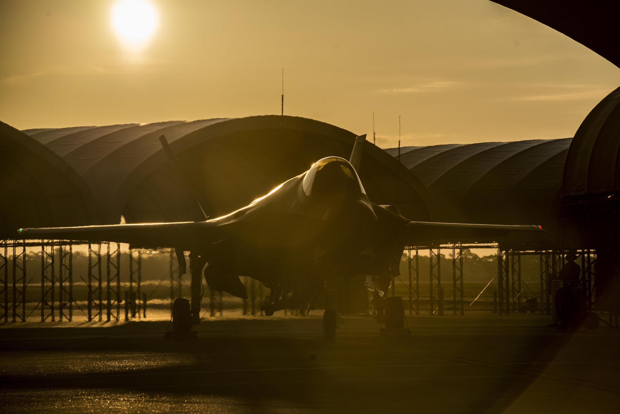 The sun rises behind an F-35A Lightning II Aug. 2, 2016, at Eglin Air Force Base, Fla. The F-35A is the latest deployable fifth-generation aircraft capable of providing air superiority, interdiction, suppression of enemy air defenses and close air support, as well as great command and control functions through fused sensors, and will provide pilots with unprecedented situational awareness of the battlespace. (U.S. Air Force photo/Senior Airman Stormy Archer)