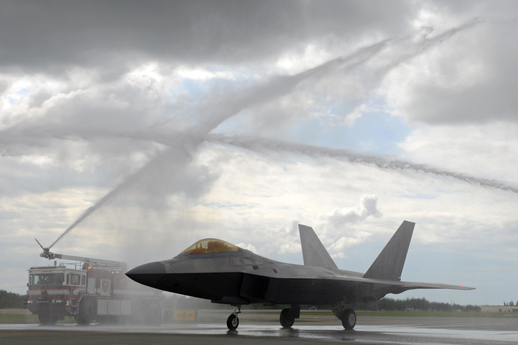 Air Force Lt. Gen. Russell Handy gets a ceremonial water salute in an F-22A Raptor following his final flight as Alaskan Command, Alaskan North American Aerospace Defense Region and 11th Air Force commander, at Joint Base Elmendorf-Richardson, Alaska, Aug. 10, 2016. Handy is the senior military officer in Alaska, responsible for the integration of all military activities in the Alaska joint operations area, synchronizing the activities of more than 21,000 active-duty and Reserve forces from all services. (U.S. Air Force photo by Airman 1st Class Javier Alvarez)