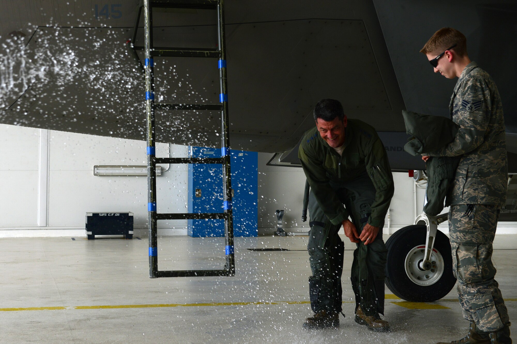 Air Force Lt. Gen. Russell Handy removes his aircrew flight equipment as he prepares to get a ceremonial hose-down after his final flight as Alaskan Command, Alaskan North American Aerospace Defense Region and 11th Air Force commander at Joint Base Elmendorf-Richardson, Alaska, Aug. 10, 2016. Handy is a command pilot with more than 3,600 flight hours, primarily in the F-15 Eagle and F-22A Raptor. He has participated in numerous combat operations and deployments, including operations Desert Shield, Desert Storm, Desert Fox, Southern Watch, Noble Eagle, Iraqi Freedom and New Dawn. (U.S. Air Force photo by Airman 1st Class Javier Alvarez)