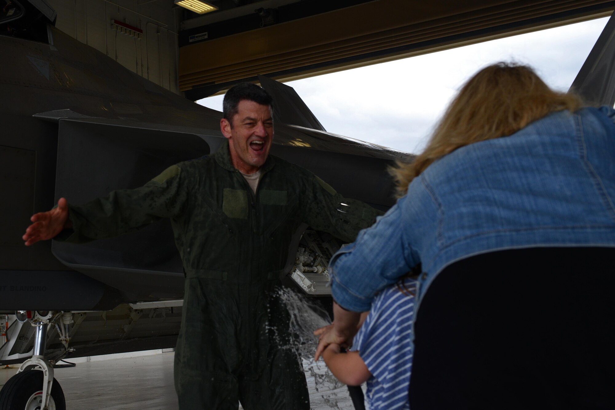 Air Force Lt. Gen. Russell Handy gets a ceremonial hose-down rom Makayla Owens, 6, and his wife JoAnn, after his final flight as Alaskan Command, Alaskan North American Aerospace Defense Region and 11th Air Force commander at Joint Base Elmendorf-Richardson, Alaska, Aug. 10, 2016. As commander of the Alaskan Region of the North American Aerospace Defense Command, Handy directs operations to ensure effective surveillance, monitoring and defense of the region’s airspace. (U.S. Air Force photo by Airman 1st Class Javier Alvarez)