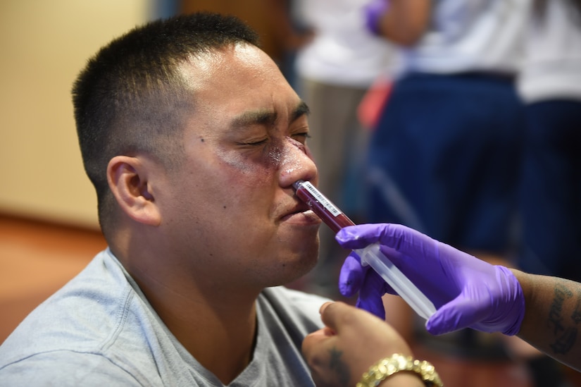 Staff Sgt. Leonardo Nolie, 11th Wing chaplain’s assistant, has a light amount of synthetic blood pumped into his nose to simulate a facial injury for the Major Accident Response Exercise at Joint Base Andrews, Md., Aug. 11, 2016. The MARE is an annual training requirement for a base to test its readiness and response capabilities. (U.S. Air Force photo by Senior Airman Joshua R. M. Dewberry)
