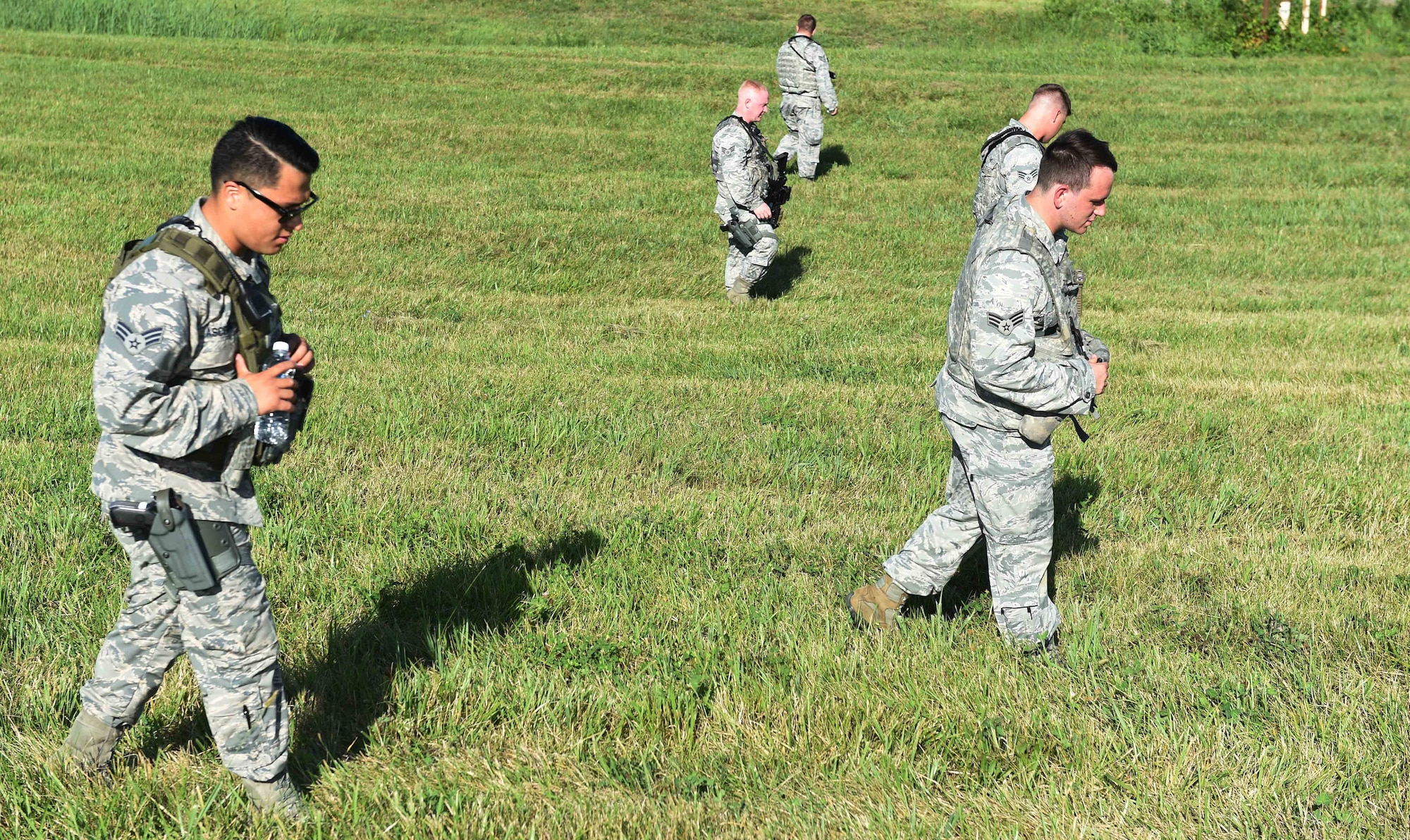 11th Wing Security Forces members sweep the accident site of a simulated F-16 aircraft crash during the Major Accident Response Exercise at Joint Base Andrews, Md., Aug. 11, 2016. The MARE is an annual training requirement for a base to test its readiness and response capabilities. (U.S. Air Force photo by Senior Airman Joshua R. M. Dewberry)