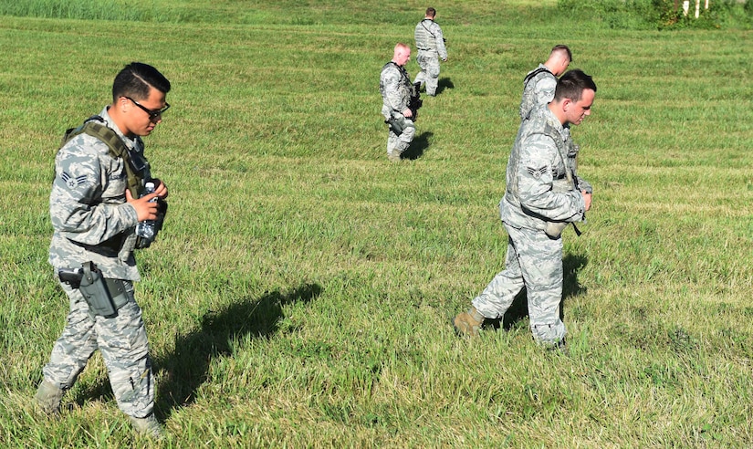 11th Wing Security Forces members sweep the accident site of a simulated F-16 aircraft crash during the Major Accident Response Exercise at Joint Base Andrews, Md., Aug. 11, 2016. The MARE is an annual training requirement for a base to test its readiness and response capabilities. (U.S. Air Force photo by Senior Airman Joshua R. M. Dewberry)