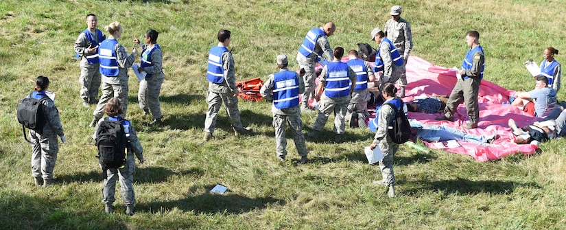 79th Medical Wing medical technicians and staff help victims and coordinate response measures at the site of a simulated F-16 aircraft crash for the Major Accident Response Exercise at Joint Base Andrews, Md., Aug. 11, 2016. The MARE is an annual training requirement for a base to test its readiness and response capabilities. (U.S. Air Force photo by Senior Airman Joshua R. M. Dewberry)