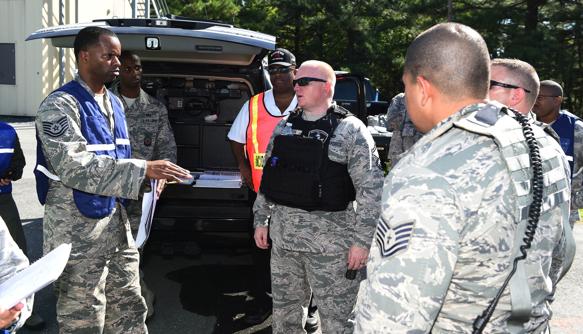 Tech Sgt. Tony Smith (left), 11th Wing Inspector General self-assessment program manager, briefs the command and control team leads from the 11th WG, 79th Medical WG, 89th Airlift WG and 113th WG coordinate response efforts at the site of a simulated F-16 aircraft crash for the Major Accident Response Exercise at Joint Base Andrews, Md., Aug. 11, 2016. The MARE is an annual training requirement for a base to test its readiness and response capabilities. (U.S. Air Force photo by Senior Airman Joshua R. M. Dewberry)