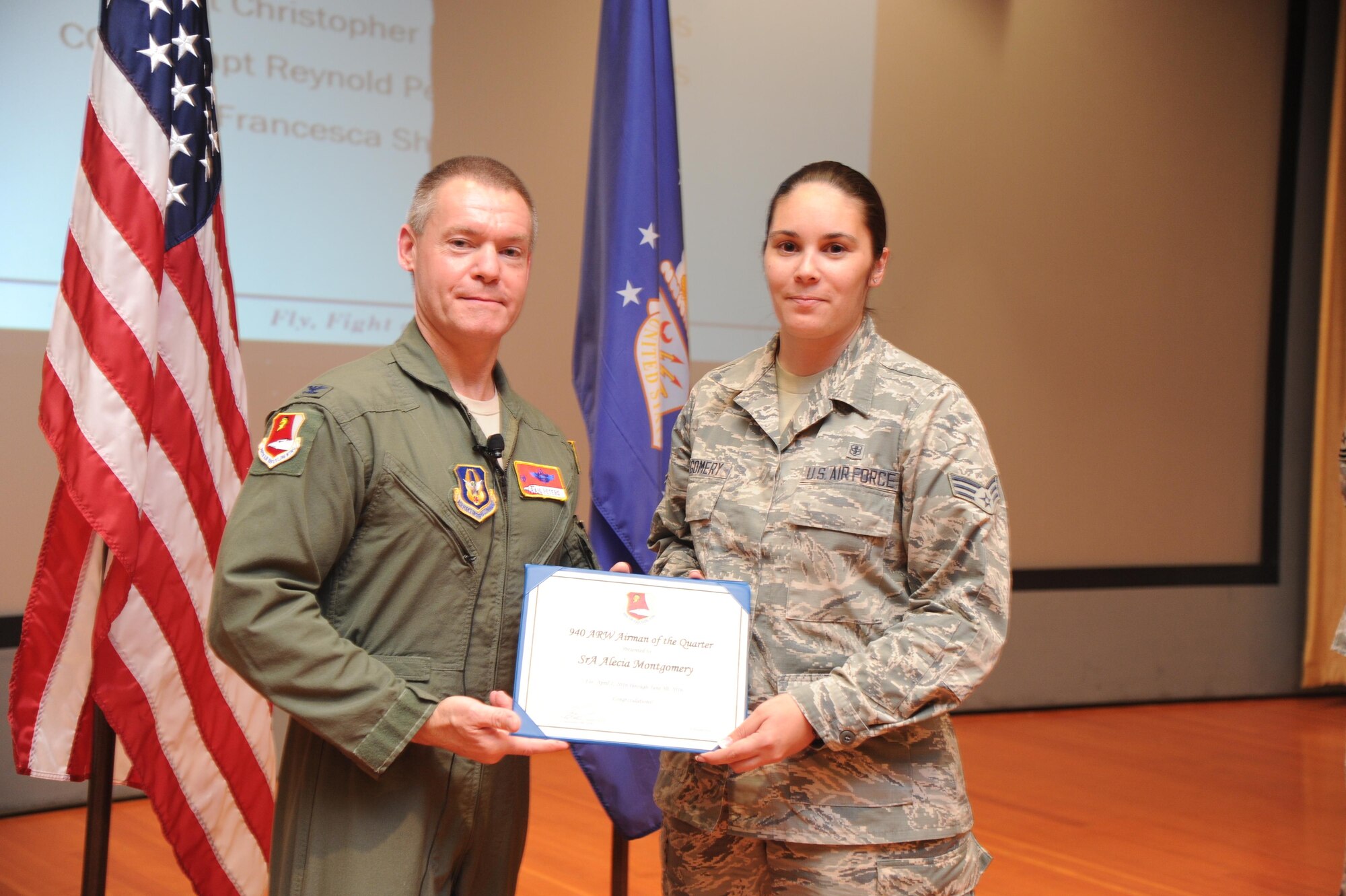 Col. Craig Peters, 940th Air Refueling Wing commander, recognizes Senior Airman Alecia Montgomery, 940th Aerospace Medicine Squadron, during a Commander's Call at Beale Air Force Base, California on August 7, 2016. Montgomery won Airman of the Quarter for her outstanding efforts during the second quarter. Three other individuals were also awarded at the event for their efforts during the second quarter as well as four individuals for the first quarter. (U.S. Air Force photo by Tech. Sgt. Heather Skinkle)