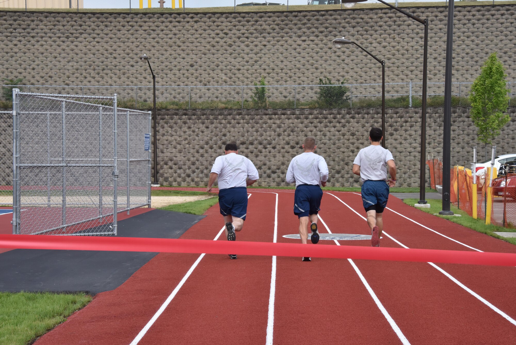 Airmen from the 911th Airlift Wing run an inaugural lap during a ribbon cutting ceremony for the Pittsburgh International Airport Air Reserve Station’s new track at the Pittsburgh IAP ARS, August 6, 2016. The track will be available to base personnel and will be used during the cardiovascular portion of physical fitness tests. (U.S. Air Force photo by Staff Sgt. Allissa Landgraff)