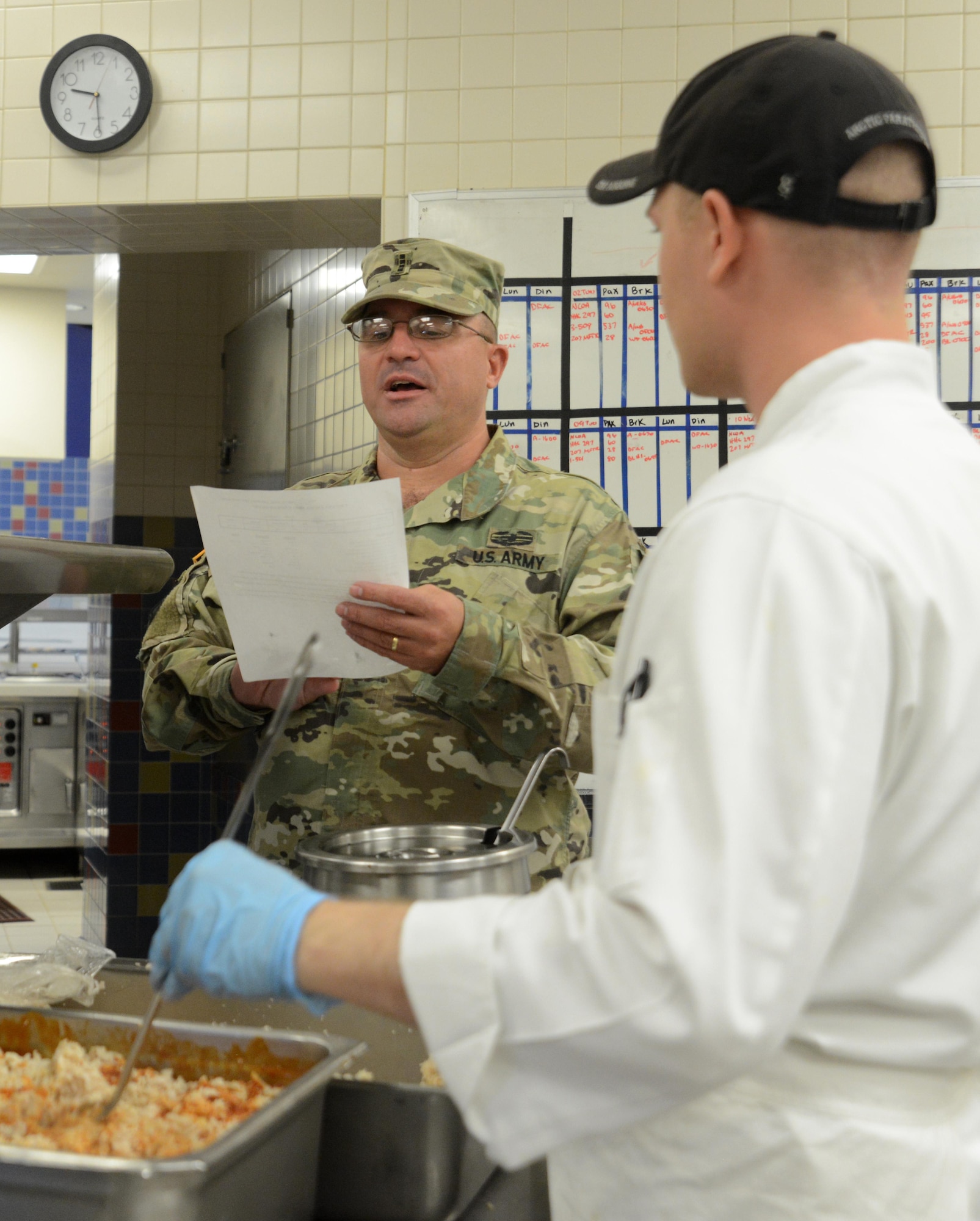 Chief Warrant Officer 4 Curtis Steineke, 402nd Army Field Support Brigade regional food program manager and a Philip A. Connelly competition evaluator, inspects food preparation at the Wilderness Inn dining facility at Joint Base Elmendorf-Richardson, Alaska, Aug. 3, 2016. The Philip A. Connelly award provides recognition for excellence in the preparation and serving of food in Army dining facilities and during field kitchen operations. (U.S. Air Force photo by Airman 1st Class Christopher R. Morales)
