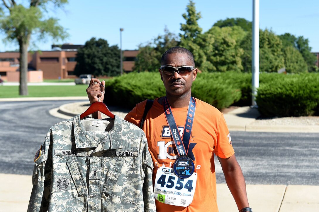 Army Reserve Chief Warrant Officer 3 Tilmon Wooden, Maintenance Officer, 85th Support Command, proudly displays his medal after completing the BTN Big 10km race. The BTN race is a competitive race for big 10 schools. "It was 73 degrees when we started," explained Wooden. He finished in 52 minutes using an 8 minute pace. Wooden likes to keep in shape by running 5K distances three times a week. "On Saturday, I run six or eight miles."
 Wooden's last race of the year will be the Fort to Base which begins at Fort Sheridan, Illinois and ends at Great Lakes Naval Base. Wooden completed the BTN race before reporting for duty on Saturday at the 85th Support Command's August Battle Assembly.
(Photo by Spc. David Lietz)