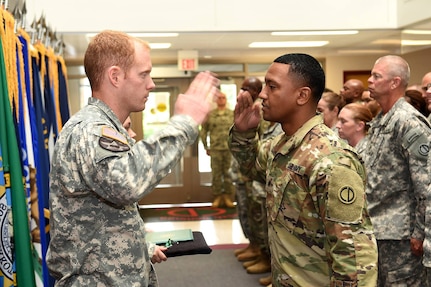 Captain Russell Litko, Headquarters & Headquarters Company commander, 85th Support Command, left, returns a salute to Sgt. Roje Rogers, Supply Sergeant, 85th Support Command, during an award ceremony presentation during the command's battle assembly, on Aug. 7, 2016. Rogers received the Army Commendation Medal during the ceremony.
(Photo by Spc. David Lietz)