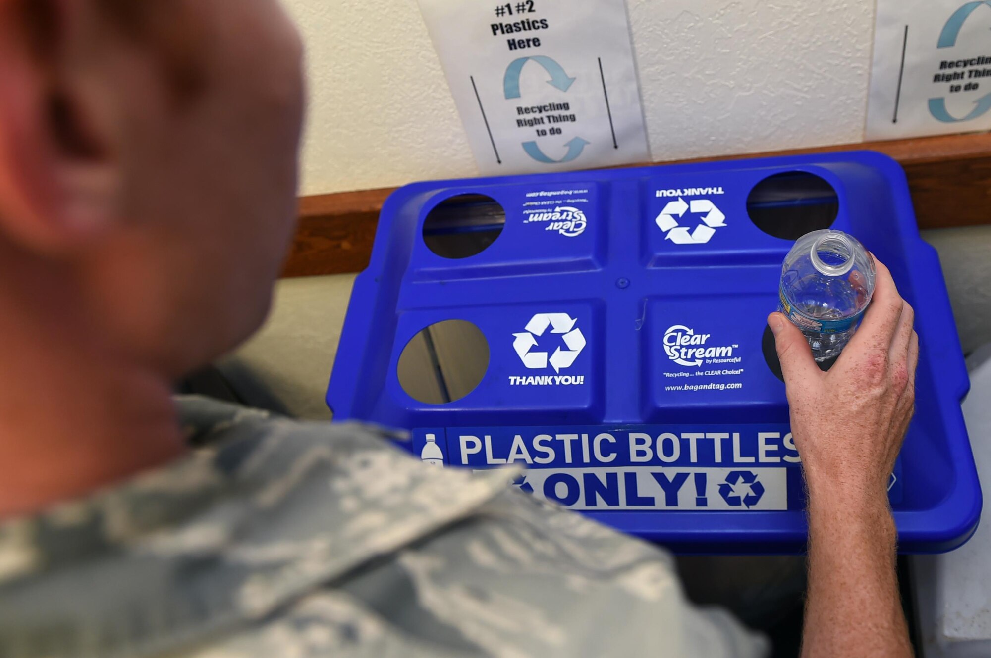 U.S. Air Force Senior Airman Nathan Clark, 97th Air Mobility Wing Public Affairs photojournalist, places a plastic bottle into a designated recycling container Aug. 12, 2016 on Altus Air Force Base, Okla. The designated recycling bins are used to separate plastic and aluminum to help reduce the amount of solid waste Altus AFB produces in accordance with the Presidential Executive Order – Planning for Federal Sustainability in the Next Decade.