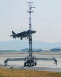 A U.S. Marine Corps AV-8B Harrier with Marine Attack Squadron (VMA) 542 performs a vertical landing while using the lights on the mobile Expeditionary Hover Position Indicator to adjust its position at Marine Corps Air Station Iwakuni, Japan, Aug. 9, 2016. VMA-542 is home based out of Marine Corps Air Station Cherry Point, N.C., and is forward deployed to MCAS Iwakuni, Japan, as part of the unit deployment program. The Harrier pilots used the mobile EHPI in coordination with Aircraft Recovery assigned to Headquarters and Headquarters Squadron to recertify on boat-deck landings to prepare for other future operations in the Pacific. 