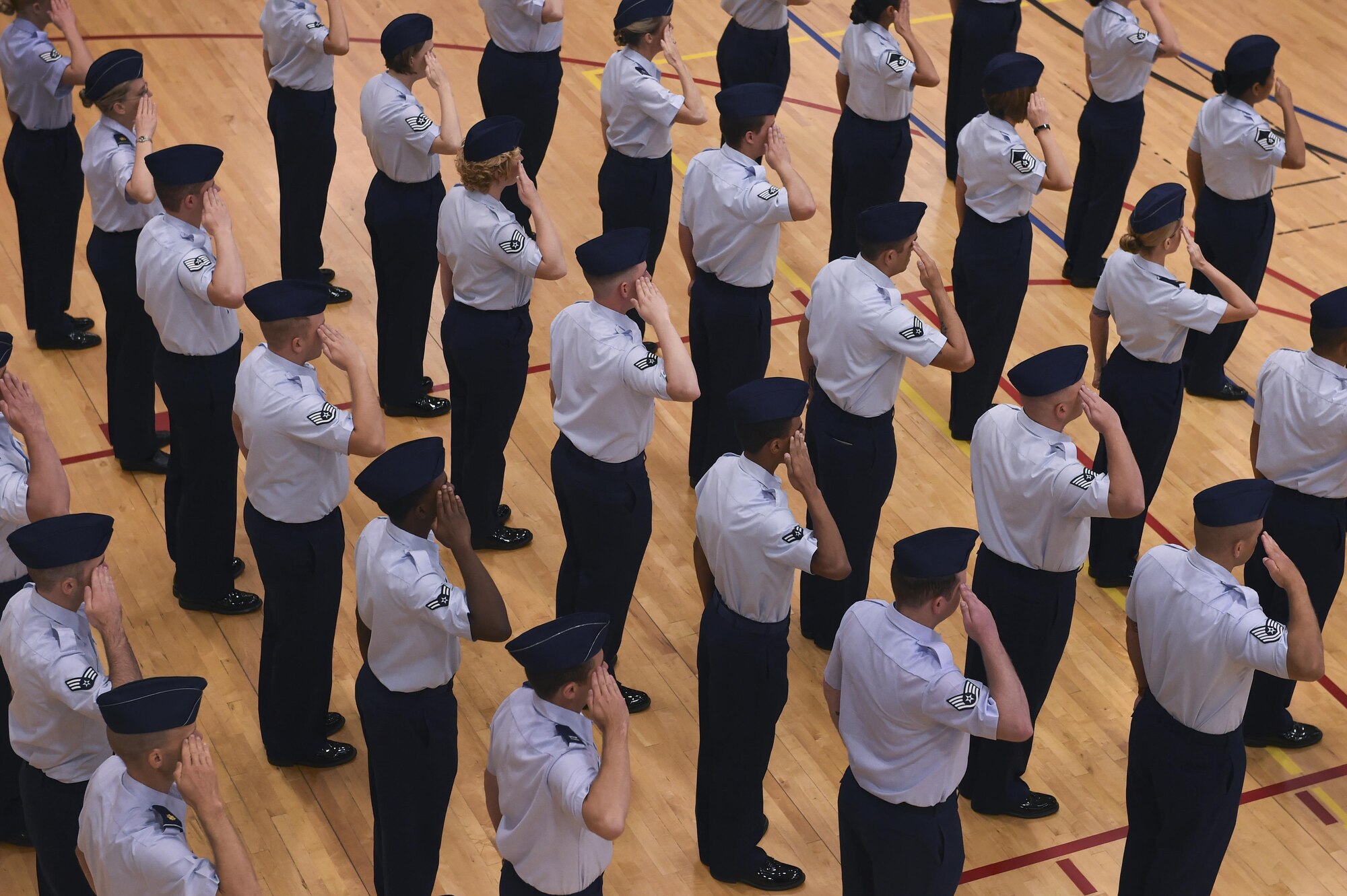 Members of the 460th Space Wing salute during the wing’s change of command ceremony August 12, 2016, at the Buckley Fitness Center on Buckley Air Force Base, Colo. Buckley AFB defends America through its air operations, space-based missile warning capabilities, space surveillance operations, space communications operations and support functions. (U.S. Air Force photo by Staff Sgt. Katrina M. Brisbin/Released)