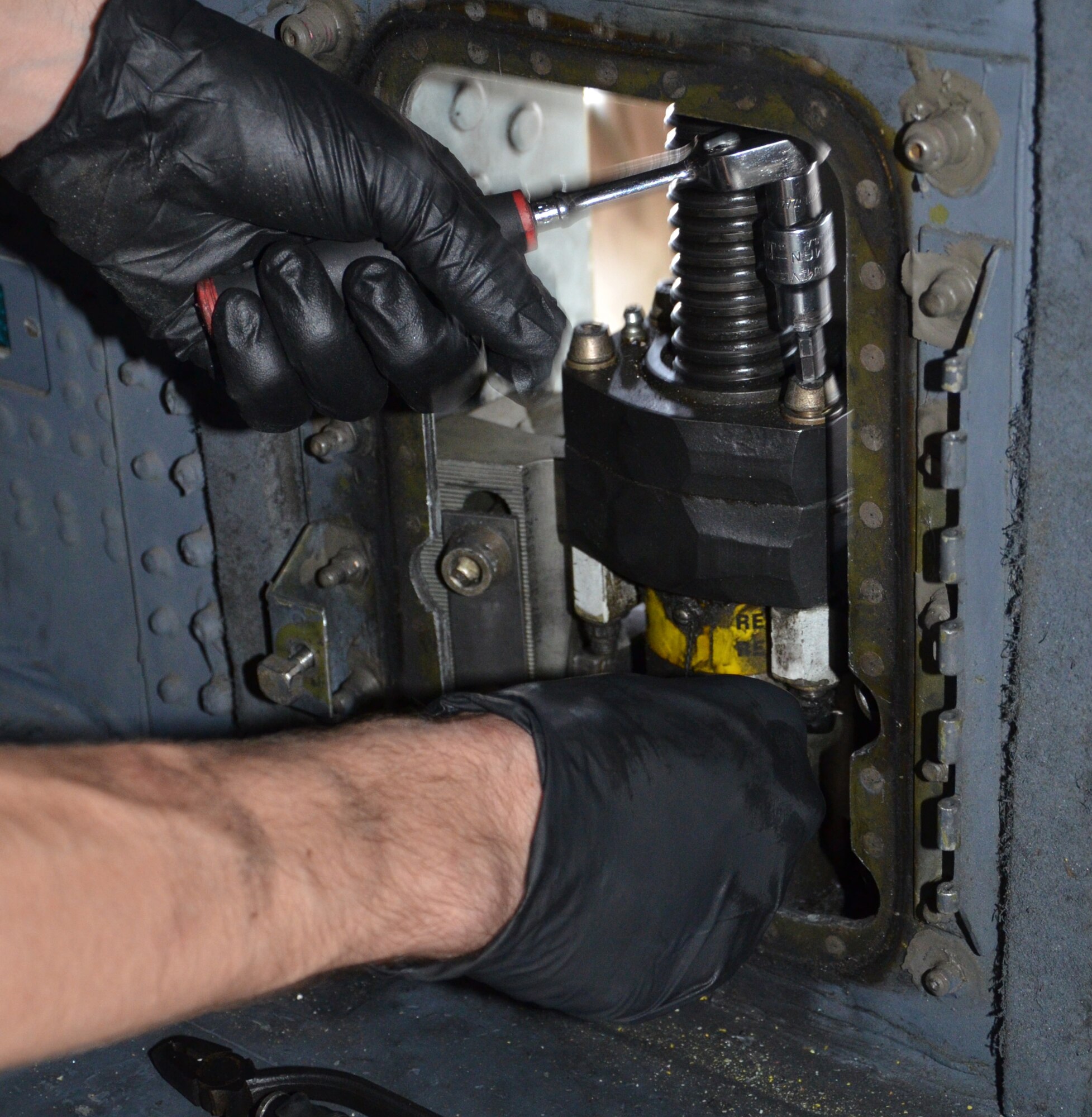 Two maintenance squadrons from the 920th Rescue Wing, Patrick Air Force Base Florida, teamed up to work on a HC-130P/N refueling aircraft, to replace its struts August 2. (U.S. Air Force Photo approved/released by Senior Airman Brandon P. Kalloo Sanes)