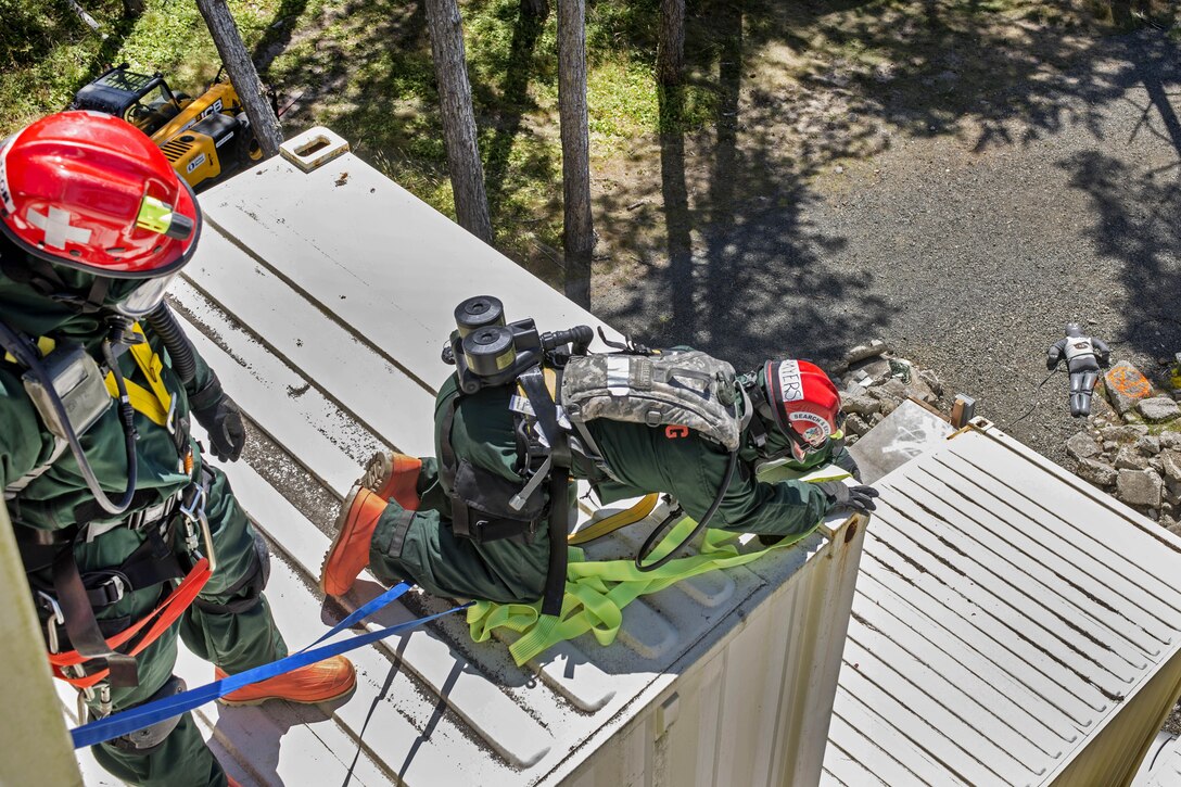 Airmen locate a medical mannequin at the top of a building during training at Camp Rilea, Warrenton, Ore., Aug. 4, 2016. The airmen, assigned to the Colorado National Guard’s 140th Fatality Search and Rescue Team, function as a recovery team, helping families find closure after properly identifying those who have lost their lives. Air National Guard photo by Staff Sgt. Bobbie Reynolds