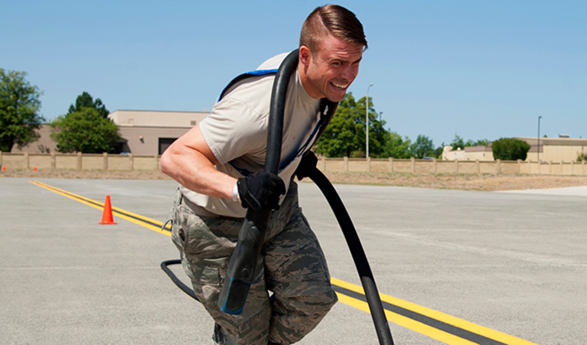 Staff. Sgt. Robert Goodman, 92nd Maintenance Group Aircraft General flying crew chief, strains to pull a 100 ft. long aircraft power cable across the flight line during the third leg of the Fairchild MXG Olympic Relay Competition on Aug. 5, 2016, at Fairchild Air Force Base, Wash. Each member of the four airman teams had to sprint across the flight line to perform their part of the relay before tagging a teammate. (U.S. Air Force photo/Airman 1st Class Ryan Lackey)