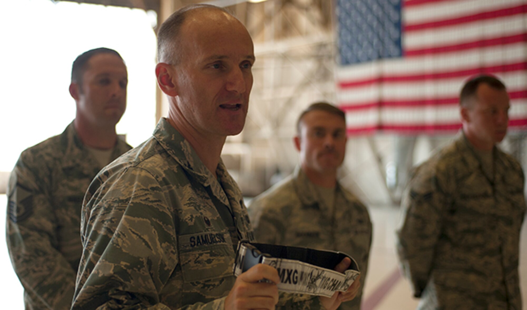 Colonel Ryan Samuelson, 92nd Air Refueling Wing commander, holds up a championship belt in front of the Fairchild Maintenance Group Olympic Relay Competition winners Aug. 5, 2016, at Fairchild Air Force Base, Wash. Samuelson encouraged the winning team to wear the ceremonial belts on the job as a sign of team pride. (U.S. Air Force photo/ Airman 1st Class Ryan Lackey)