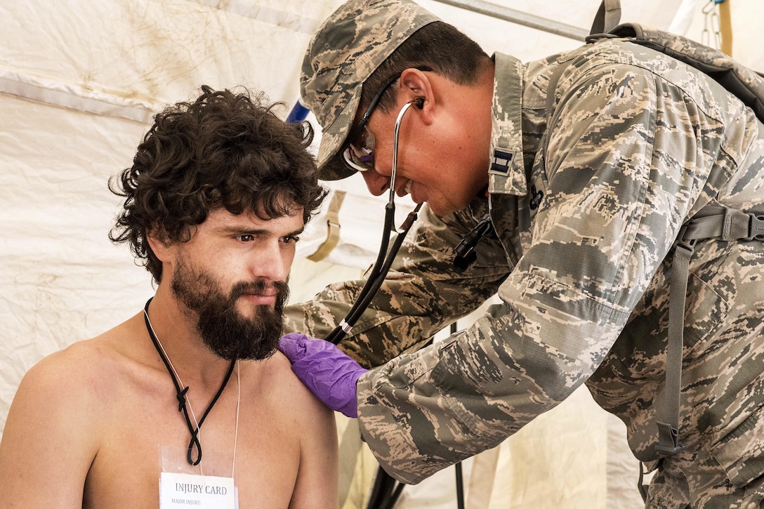 Air Force Capt. Thomas J. Dishion checks the vital signs of a role- playing casualty during a joint exercise evaluation at Camp Rilea, Warrenton, Ore., Aug. 5, 2016. Dishion is a physician assistant assigned to the Colorado National Guard’s 140th Medical Group. Air National Guard photo by Staff Sgt. Bobbie Reynolds