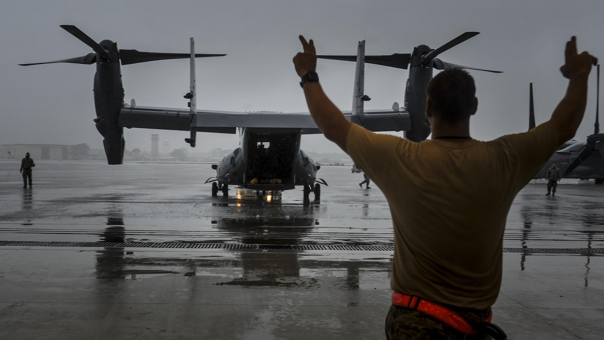 Staff Sgt. Robert Hillyard, a crew chief with the 801st Special Operations Aircraft Maintenance Squadron, guides a CV-22B Osprey tiltrotor aircraft into the Freedom Hangar at Hurlburt Field, Fla., Aug. 11, 2016. The CV-22 was brought into the hangar for scheduled maintenance. (U.S. Air Force photo by Airman Dennis Spain)