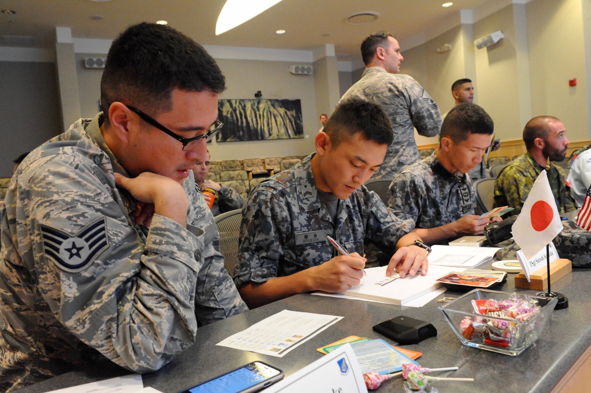 U.S. Air Force Staff Sgt. Ryuta Riecke, left, a linguist assigned to the 8th Intelligence Squadron at Hickam Air Force Base, Hawaii, translates for Japan Air Self-Defense Force Tech. Sgt. Satoshi Kushida, center, during a leadership activity at the first U.S. led, Pacific Rim Junior Enlisted Leadership Forum (JELF) at Joint Base Pearl Harbor-Hickam, Hawaii, Aug 8. 2016. The service members came together from 11 different countries to share experiences and to gain valuable insight on leadership development in order to grow as tomorrow's senior enlisted leaders.  (U.S. Air Force photo by Staff Sgt. Kamaile Chan)