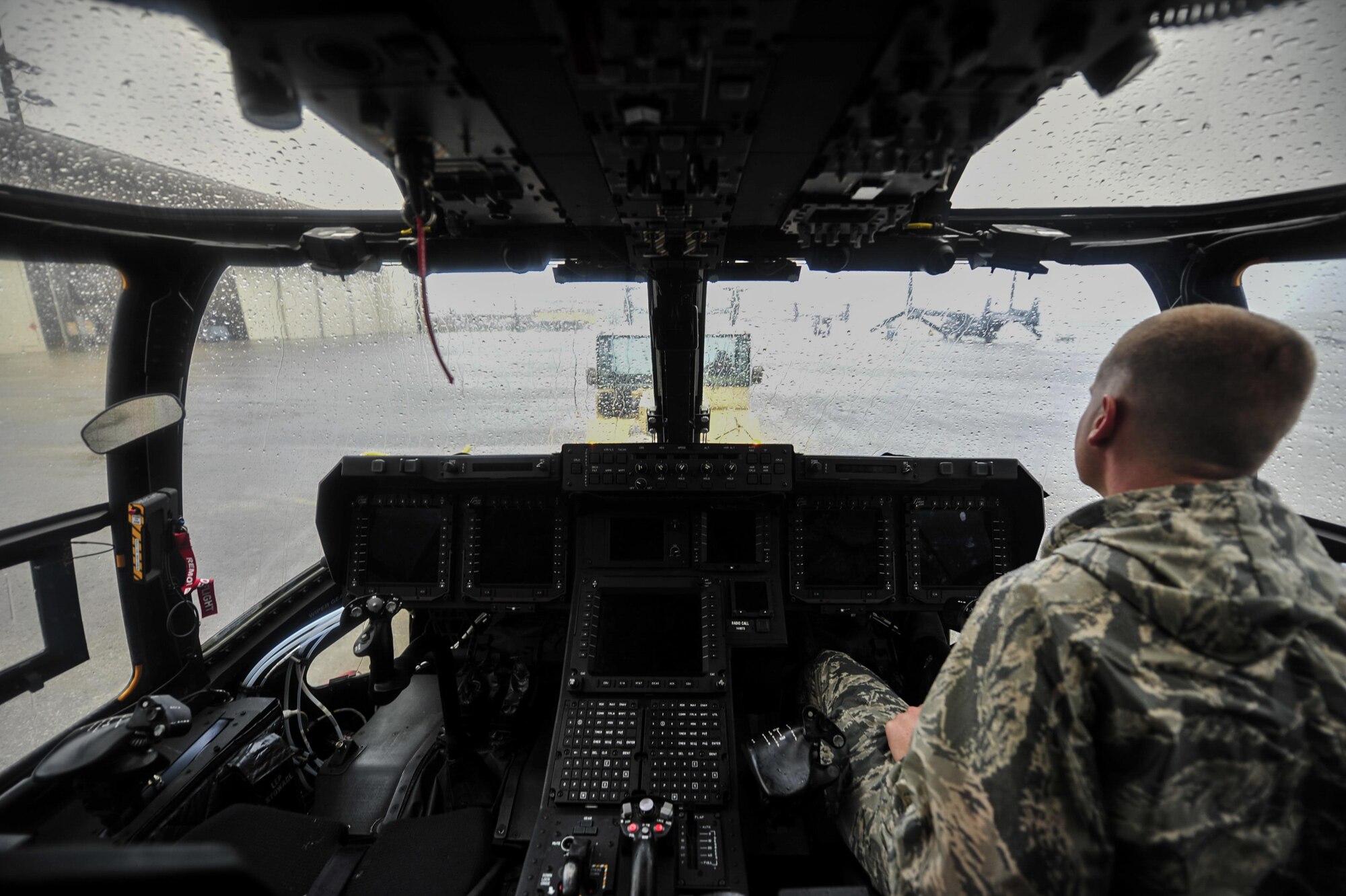 Staff Sgt. Jonathan Knutson, a crew chief with the 801st Special Operations Aircraft Maintenance Squadron, operates the brakes of a CV-22B Osprey tiltrotor aircraft while it’s towed into Freedom Hangar at Hurlburt Field, Fla., Aug. 11, 2016. The 801st SOAMXS crew chiefs continued normal operations despite the inclement weather. (U.S. Air Force photo by Airman 1st Class Joseph Pick)