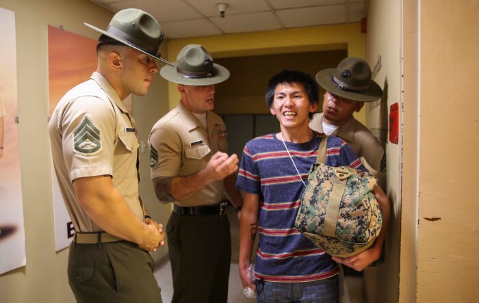Drill instructors from Receiving Company, Support Battalion, instruct a recruit to yell louder during receiving at Marine Corps Recruit Depot San Diego, Aug. 8. While recruits are on the depot, they will have drill instructors supervising them every day, everywhere they go. Annually, more than 17,000 males recruited from the Western Recruiting Region are trained at MCRD San Diego. Delta Company is scheduled to graduate Nov. 4.