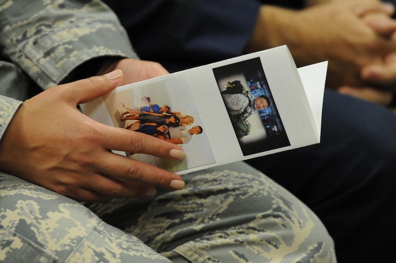 An Airman views an event program during a room dedication ceremony to honor Maj. W. David Gray in Cody Hall Aug. 8, 2016, on Keesler Air Force Base, Miss. Gray served for several years as an airfield operations officer and was killed in action in Afghanistan on Aug. 8, 2012. A tower lab training room was dedicated during the event. (U.S. Air Force photo by Kemberly Groue/Released)