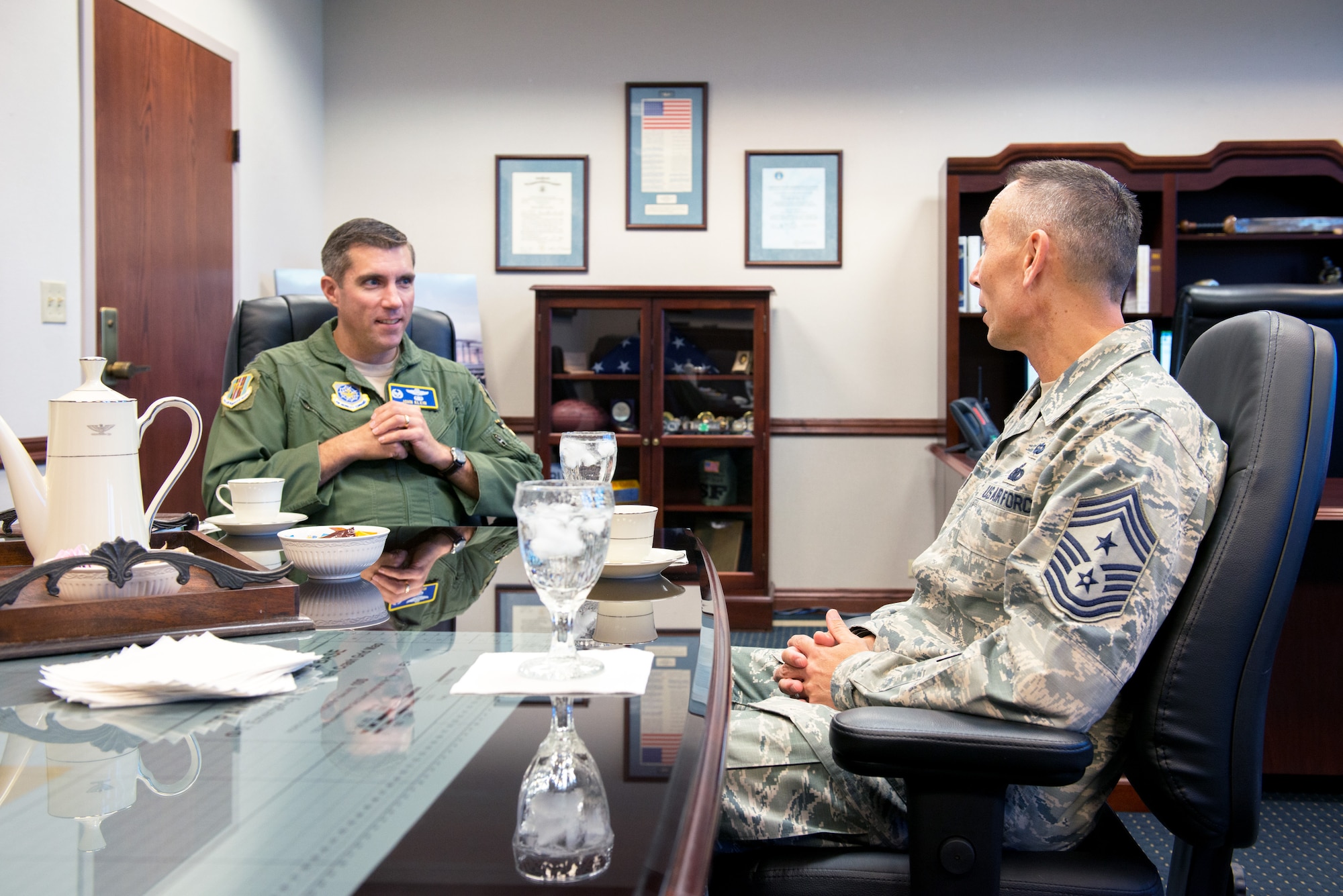 U.S. Air Force Chief Master Sgt. Todd Petzel, 18th Air Force command chief, Scott Air Force Base, Ill., meets with Col. John Klein, 60th Air Mobility Wing commander, during a visit to Travis Air Force Base, Calif., Aug. 12, 2016. Petzel visited Travis AFB to provide remarks as the guest speaker for the Senior Non-Commissioned Officer Induction ceremony. (U.S. Air Force photo by Louis Briscese)