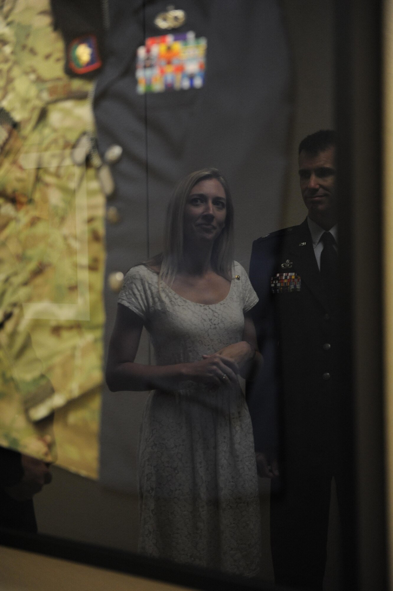 Heather Gray Blalock looks at a shadow box containing military uniforms of her late husband, Maj. W. David Gray, during a room dedication ceremony at Cody Hall , Aug. 8, 2016, on Keesler Air Force Base, Miss. Gray served for several years as an airfield operations officer and was killed in action in Afghanistan on Aug. 8, 2012. A tower lab training room was dedicated during the event. (U.S. Air Force photo by Kemberly Groue/Released)