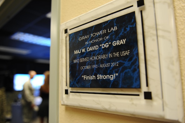 A plaque honoring Maj. W. David Gray hangs outside of a tower lab training room in Cody Hall Aug. 8, 2016, on Keesler Air Force Base, Miss. Gray served for several years as an airfield operations officer and was killed in action in Afghanistan on Aug. 8, 2012. (U.S. Air Force photo by Kemberly Groue/Released)
