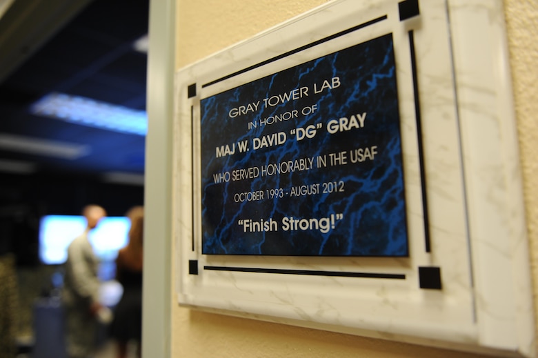 A plaque honoring Maj. W. David Gray hangs outside of a tower lab training room in Cody Hall Aug. 8, 2016, on Keesler Air Force Base, Miss. Gray served for several years as an airfield operations officer and was killed in action in Afghanistan on Aug. 8, 2012. (U.S. Air Force photo by Kemberly Groue/Released)