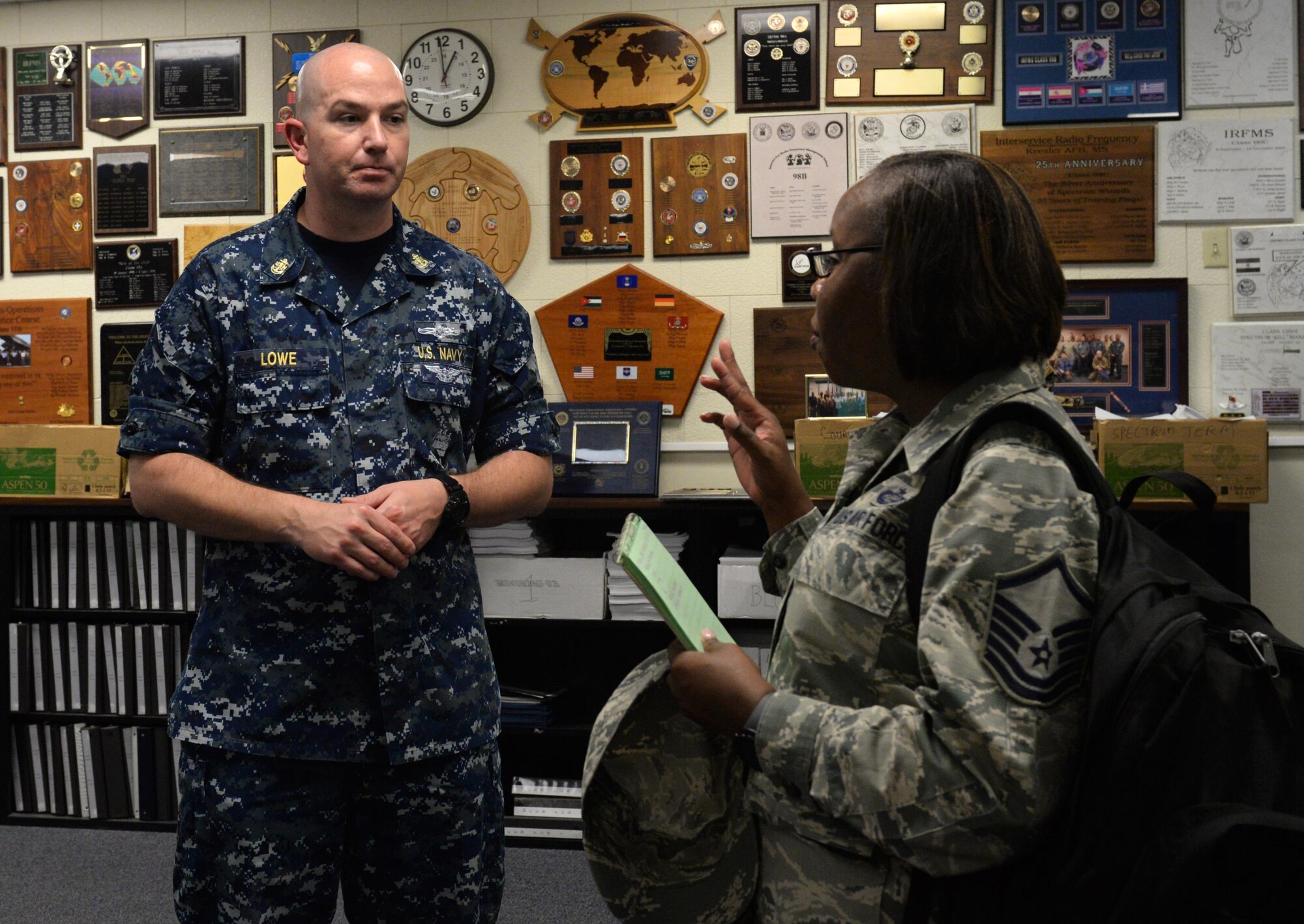 Master Sgt. Alicia Barley, Community College of the Air Force campus affiliations flight chief, asks Navy Chief Petty Officer Noah Lowe, 333rd Training Squadron instructor supervisor, questions about the spectrum operations apprentice course at McClelland Hall Aug. 9, 2016, on Keesler Air Force Base, Miss. The CCAF inspection team visited the 81st Training Group to assess class curriculums to ensure Keesler maintains its accreditation so students can receive college credits for their completed technical schools. (U.S. Air Force photo by Airman 1st Class Travis Beihl/Released)