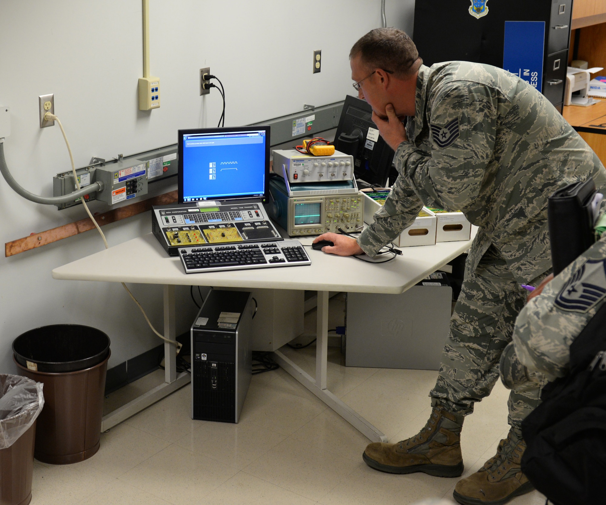 Tech. Sgt. Chad Quesenberry, 335th Training Squadron instructor supervisor, demonstrates the functions of a Nida electronic trainer to members of the Community College of the Air Force inspection team at Wolfe Hall Aug. 10, 2016, on Keesler Air Force Base, Miss. The CCAF inspection team visited the 81st Training Group to assess class curriculums to ensure Keesler maintains its accreditation so students can receive college credits for their completed technical schools. (U.S. Air Force photo by Airman 1st Class Travis Beihl/Released)