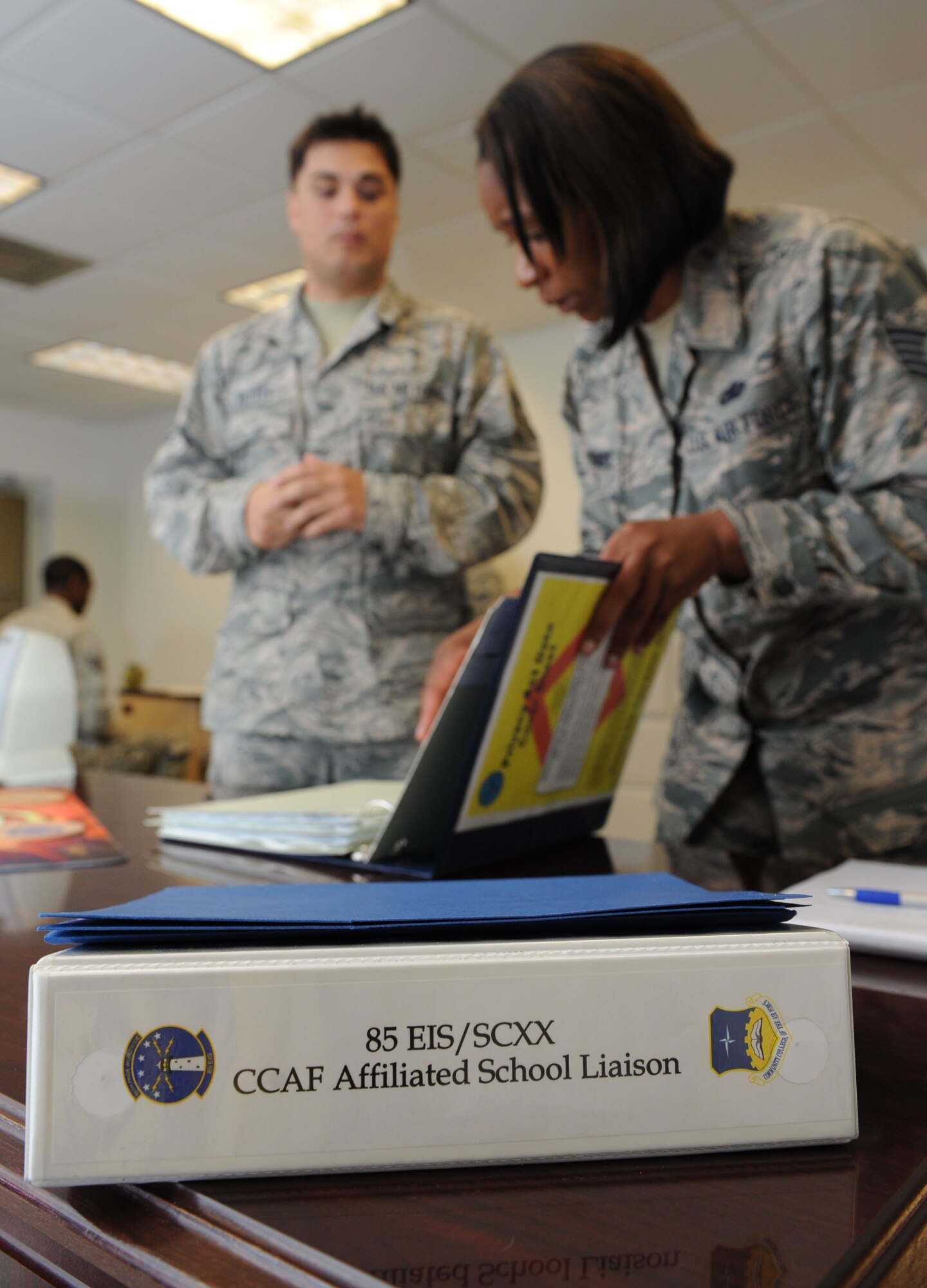 Tech. Sgt. Virgil Putzke, 85th Engineering Installation Squadron force development NCO in charge, assists Tech. Sgt. Benita Casemere, Community College of the Air Force affiliate school manager, during an inspection at Maltby Hall Aug. 11, 2016, on Keesler Air Force Base, Miss. The CCAF inspection team visited the 81st Training Group to assess class curriculums to ensure Keesler maintains its accreditation so students can receive college credits for their completed technical schools. (U.S. Air Force photo by Kemberly Groue/Released)