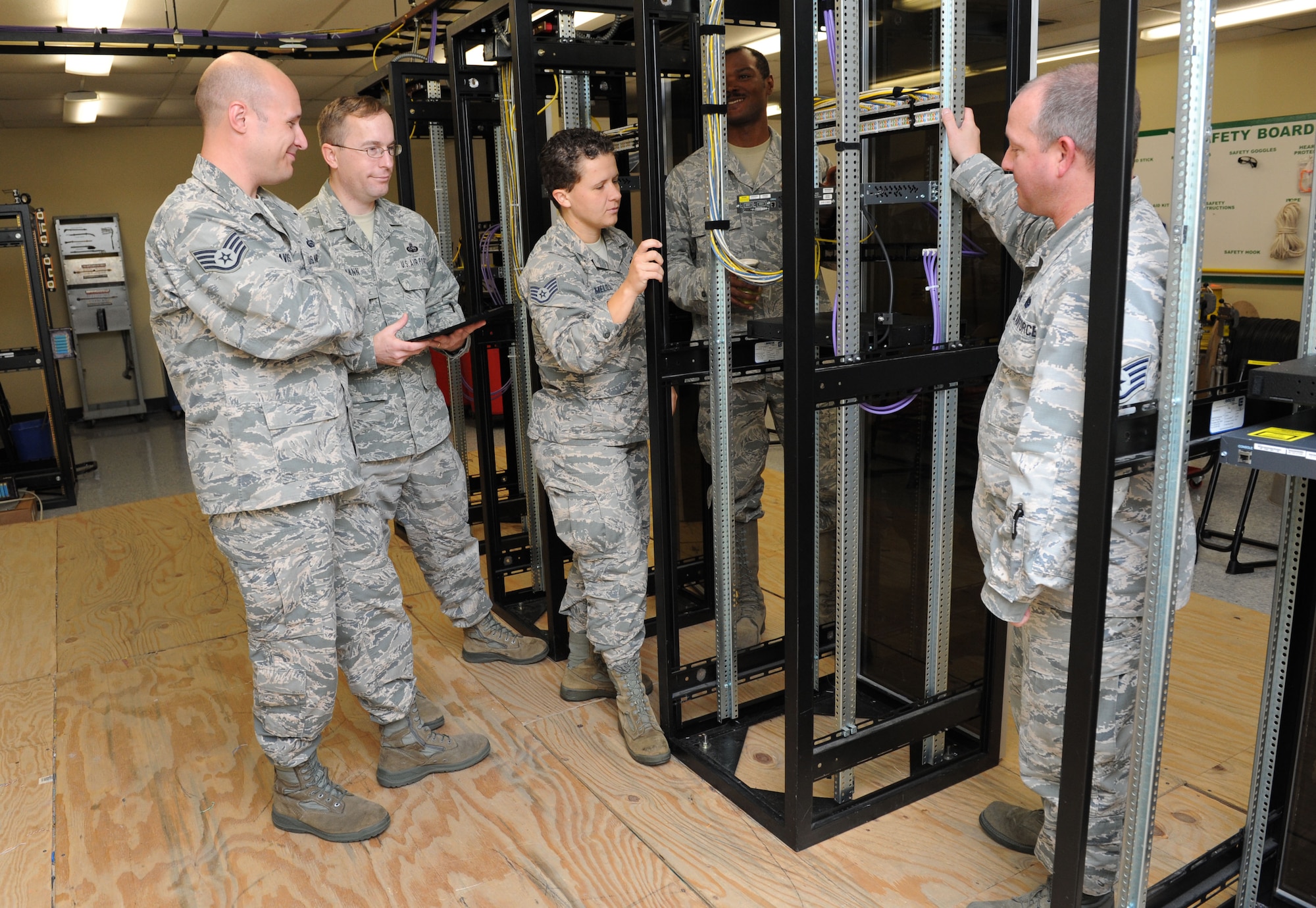 Members of the Community College of the Air Force Compliance Requirements Visit team receive a tour of the 85th Engineering Installation Squadron at Maltby Hall Aug. 11, 2016, on Keesler Air Force Base, Miss. The CCAF inspection team visited the 81st Training Group to assess class curriculums to ensure Keesler maintains its accreditation so students can receive college credits for their completed technical schools. (U.S. Air Force photo by Kemberly Groue/Released)