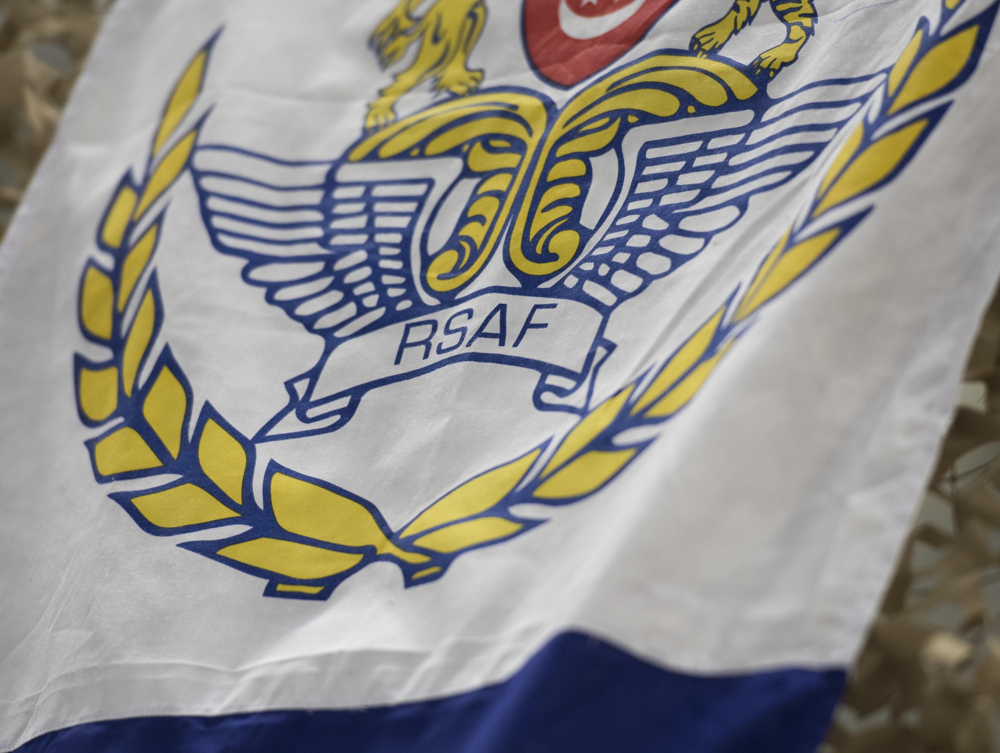 The Republic of Singapore Air Force crest is displayed on a flag at the National Day celebration, August 5, 2016 at Mountain Home AFB. The crest symbolizes equality, peace, progress, democracy and justice. (U.S. Air Force photo by Airman Alaysia Berry/Released)