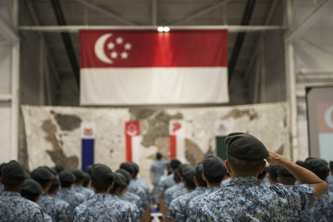 Members of the 428th Fighter Squadron stand in formation in front of the Singaporean flag August 5, 2016, at Mountain Home AFB, Idaho. The colors of the flag represent: red for brotherhood and equality, and white for purity and value.  (U.S. Air Force photo by 2nd Lt. Kippun Sumner/Released)