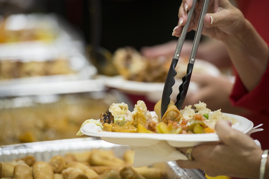 The volunteers at the National Day celebration served curry, pork fried rice, sweet and sour pork and Pandan cake August 5, 2016 at Mountain Home Air Force Base. Attendees included members of the 428th Fighter Squadron and their families, Gunfighters and local community members. (U.S. Air Force photo by 2nd Lt. Kippun Sumner/Released)